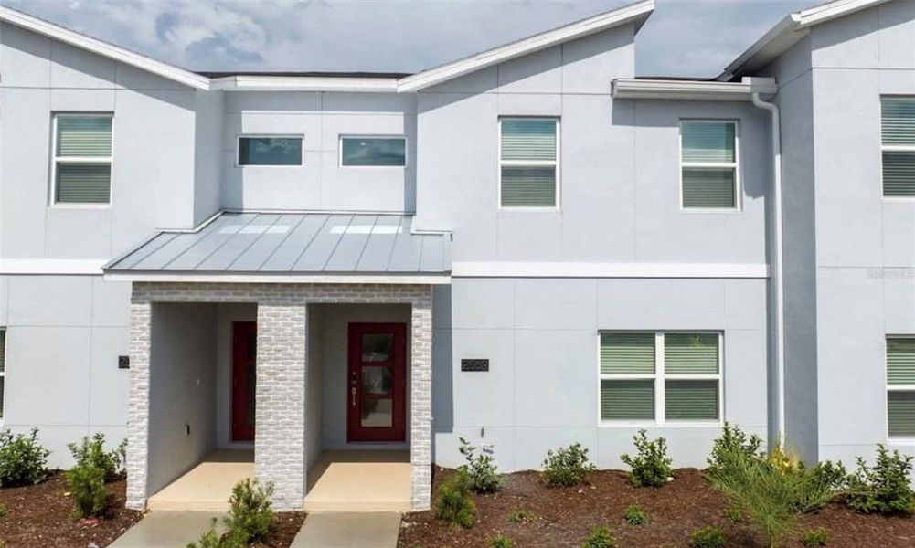 Front exterior of a new home in , Kissimmee, FL, highlighting curb appeal (Image 1).