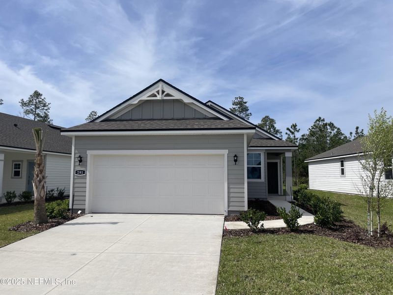 Front exterior of a new home in Palm Series at Seminole Palms, Palm Coast, FL, highlighting curb appeal (Image 23).