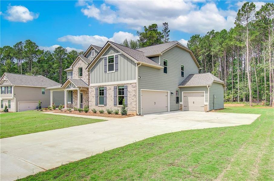 Front exterior of a new home in Grandview at Millers Mill, Stockbridge, GA, highlighting curb appeal (Image 19). Front exterior of a new home in Grandview at Millers Mill, Stockbridge, GA, highlighting curb appeal (Image 19).