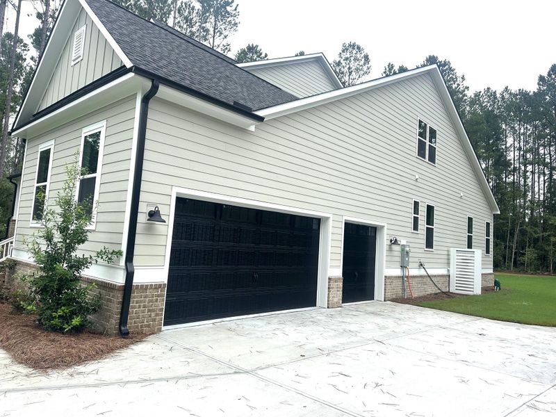 Front exterior of a new home in , Moncks Corner, SC, highlighting curb appeal (Image 1). Front exterior of a new home in , Moncks Corner, SC, highlighting curb appeal (Image 1).