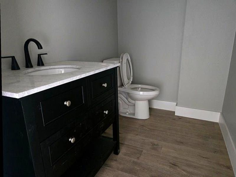 Bathroom featuring vanity and dark wood-style floors