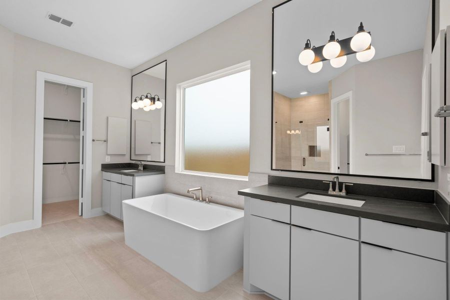 The main suite is beautifully appointed with high-end finishes and a soaker tub