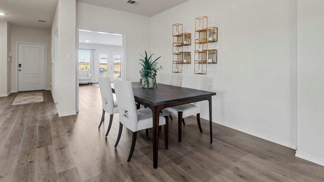 Dining area with dark wood-type flooring