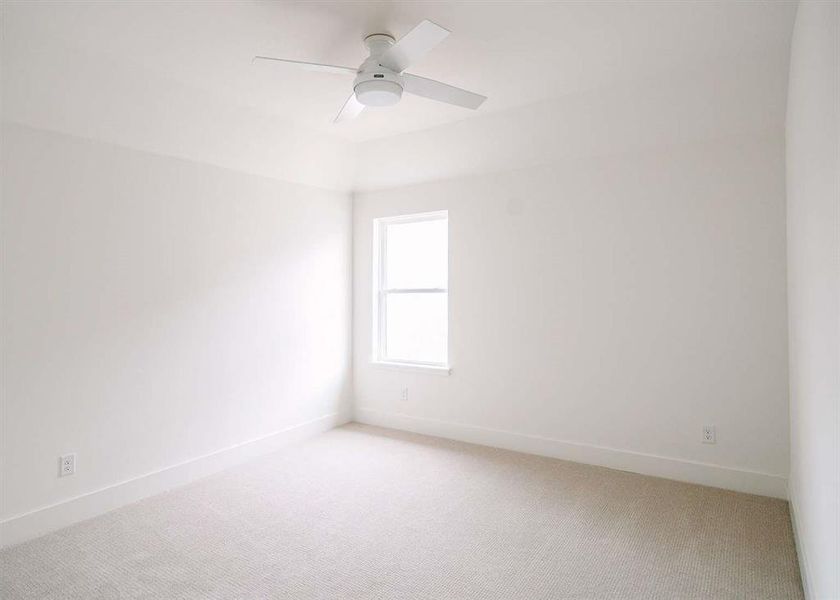 Spare room with carpet flooring and ceiling fan