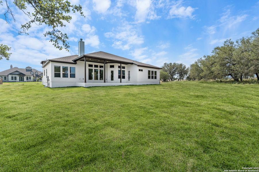 Front exterior of a new home in Legend Park, Castroville, TX, highlighting curb appeal (Image 19). Front exterior of a new home in Legend Park, Castroville, TX, highlighting curb appeal (Image 19).