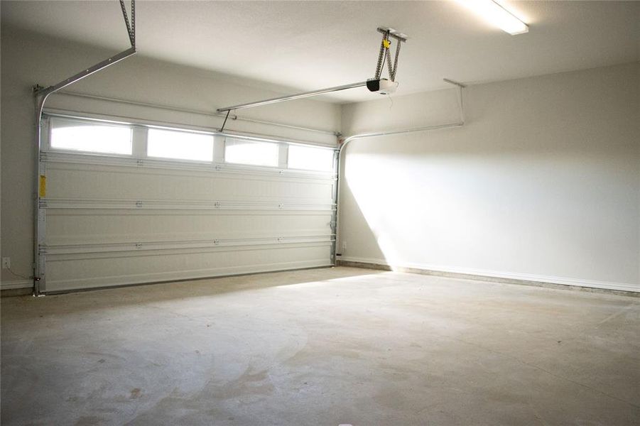 Garage featuring a garage door opener