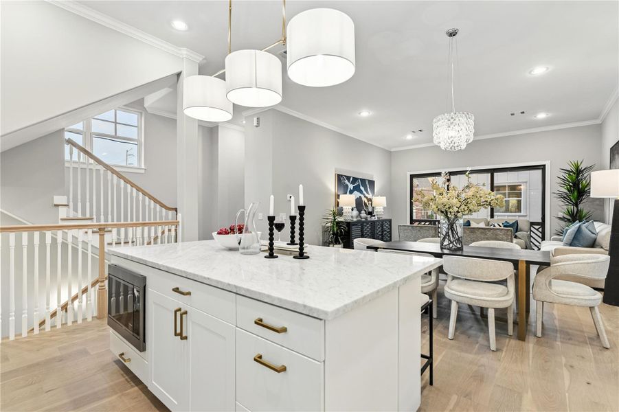 The well-appointed kitchen and island. Equipped with designer lighting and Thermador appliances.