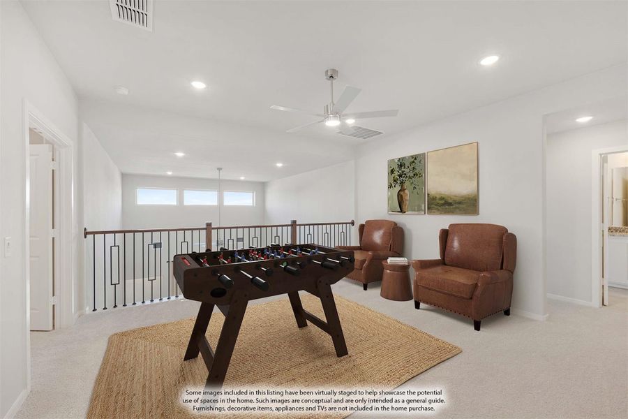 Upstairs loft game room with foosball table, two leather chairs, ceiling fan, and open railing overlooking lower floor Upstairs loft game room with foosball table, two leather chairs, ceiling fan, and open railing overlooking lower floor