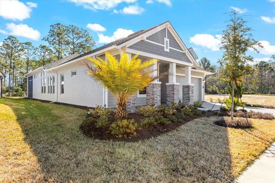 Front exterior of a new home in Woodhaven, Port Orange, FL, highlighting curb appeal (Image 26). Front exterior of a new home in Woodhaven, Port Orange, FL, highlighting curb appeal (Image 26).