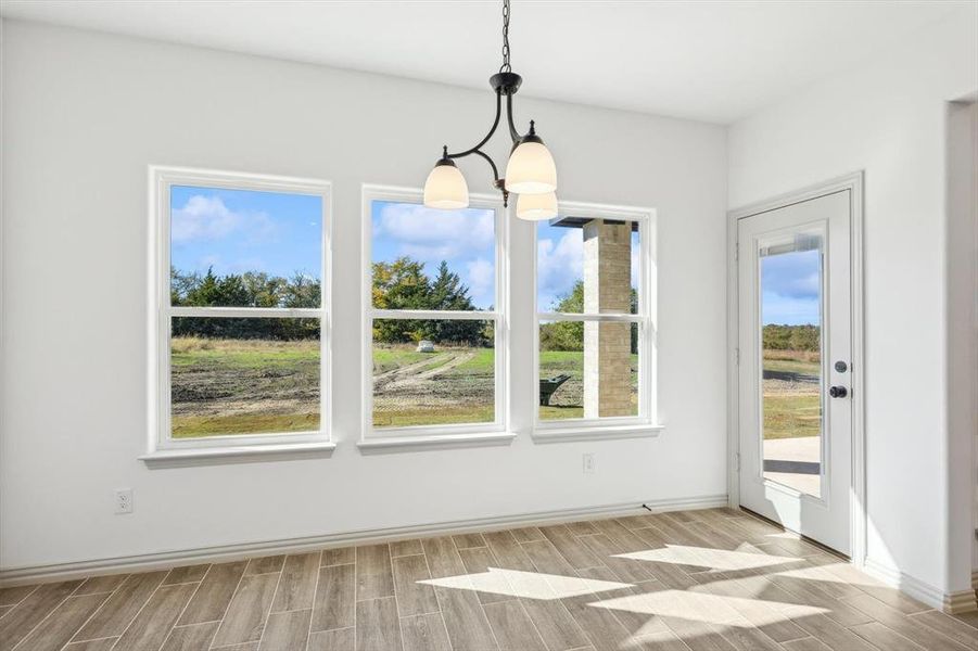 Unfurnished dining area featuring light wood-type flooring