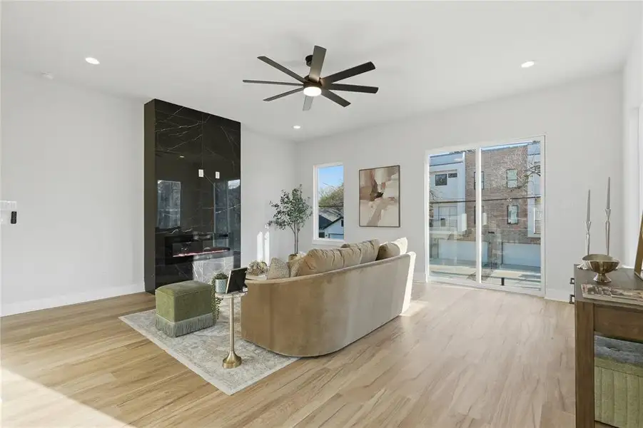 Living room featuring light wood finished floors, a ceiling fan, and recessed lighting Living room featuring light wood finished floors, a ceiling fan, and recessed lighting