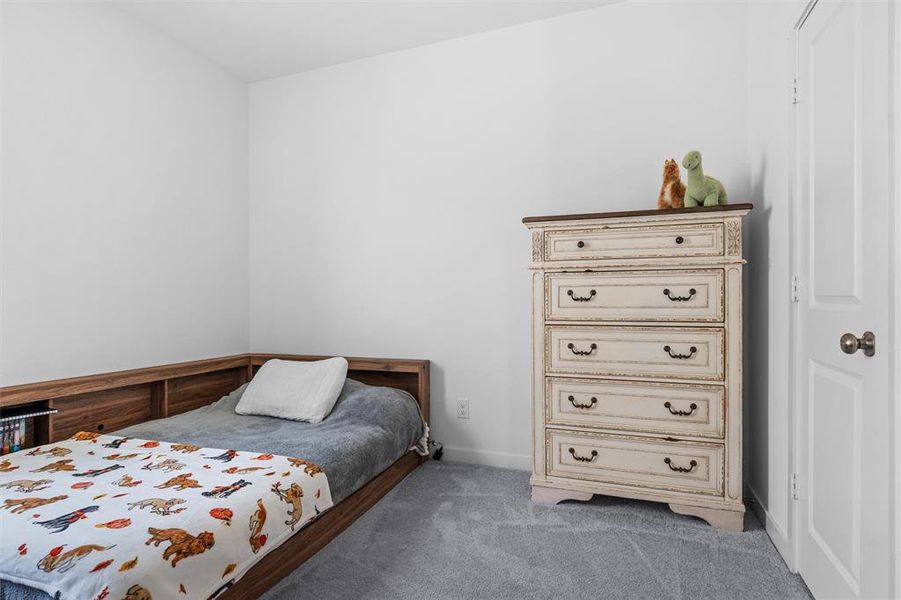 Carpeted bedroom with baseboards Carpeted bedroom with baseboards