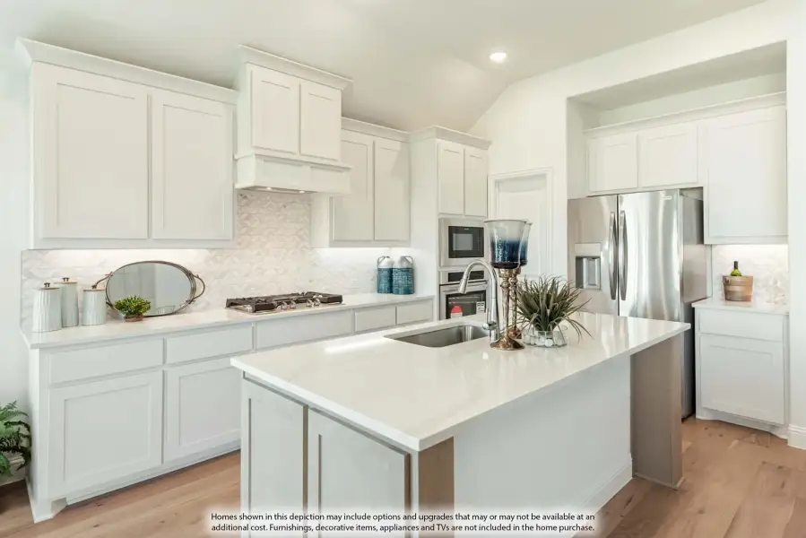 Kitchen with white cabinets, center island with sink, stainless steel appliances, and light wood floors