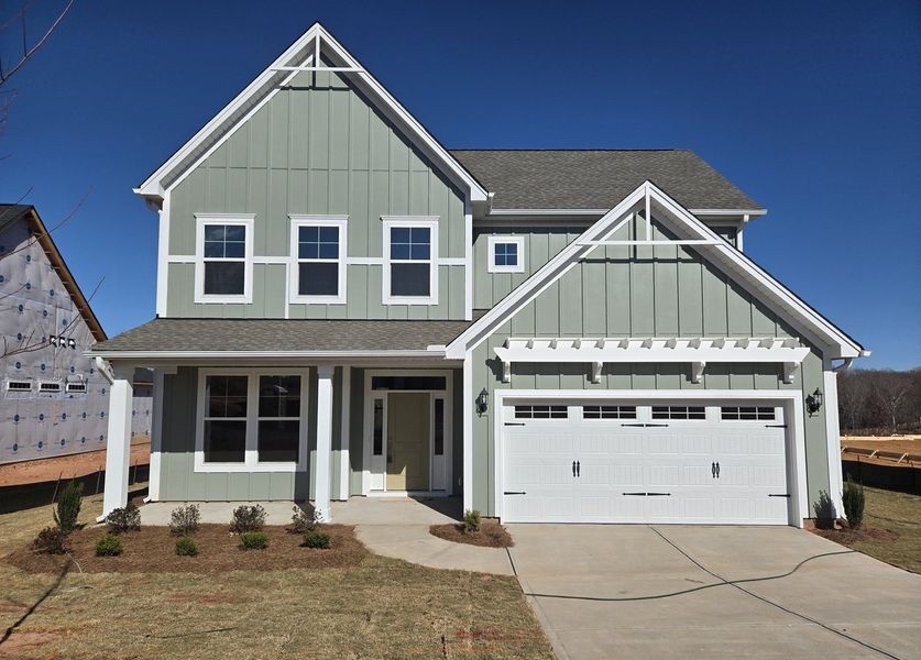 Front exterior of a new home in Cottages at Lake Emory, Inman, SC, highlighting curb appeal (Image 1). Front exterior of a new home in Cottages at Lake Emory, Inman, SC, highlighting curb appeal (Image 1).