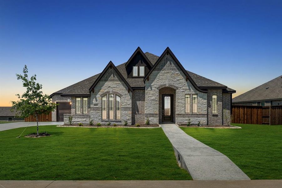 Front exterior of a new home in Wildcat Ridge, Godley, TX, highlighting curb appeal (Image 25). Front exterior of a new home in Wildcat Ridge, Godley, TX, highlighting curb appeal (Image 25).
