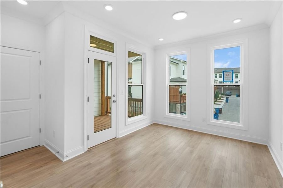 Bright and airy, the sunroom is surrounded by windows that fill the space with natural light and offer serene views of the outdoors.