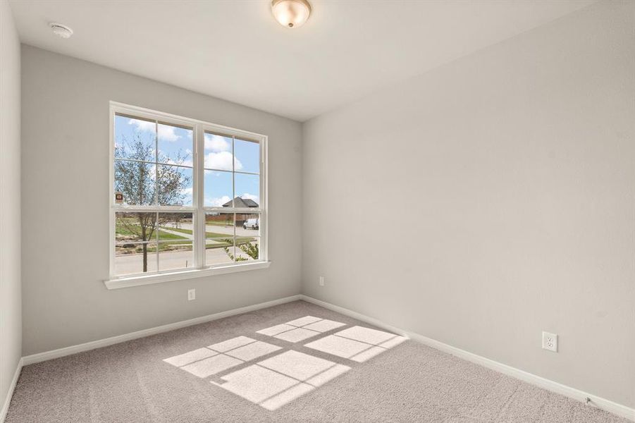 Your secondary bedroom features plush carpet, fresh paint, closet, and a large window that lets in plenty of natural lighting.