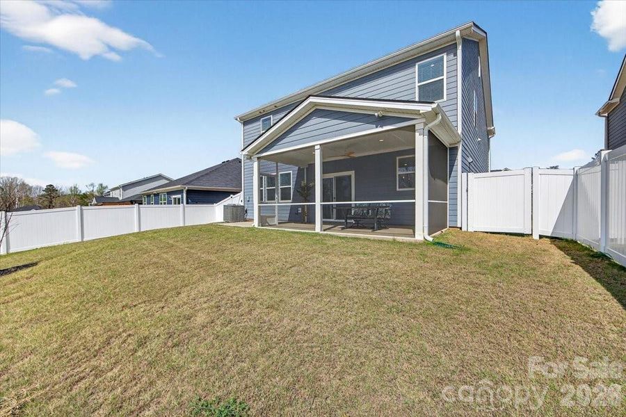 Fenced backyard with 6' vinyl privacy fence.