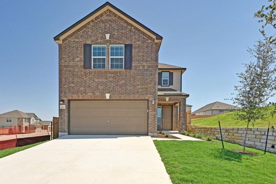 Front exterior of a new home in Creekside at Estancia, Austin, TX, highlighting curb appeal (Image 2). Front exterior of a new home in Creekside at Estancia, Austin, TX, highlighting curb appeal (Image 2).
