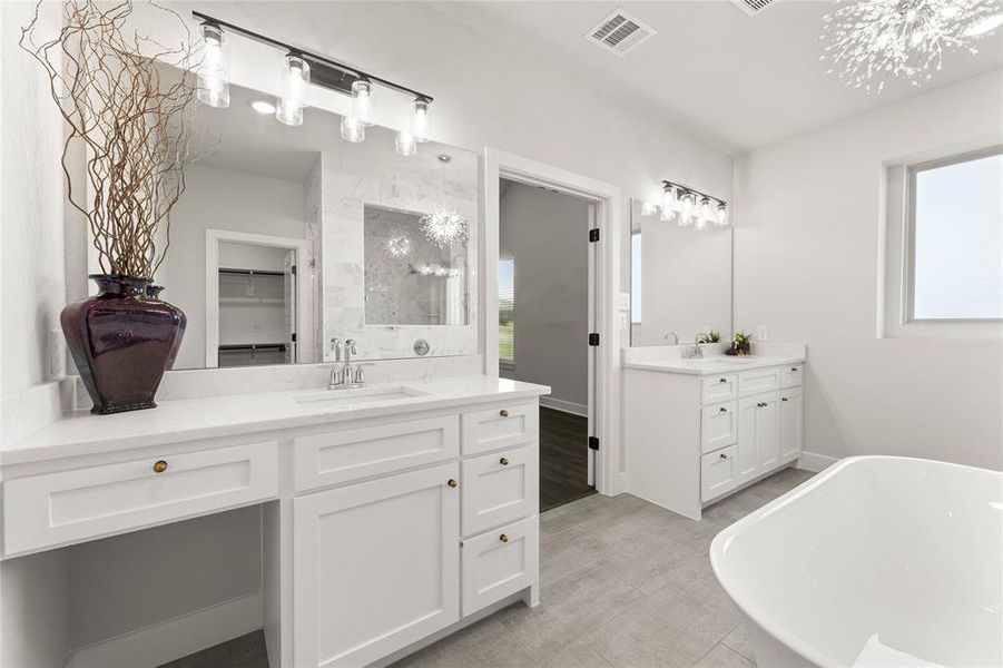 Bathroom featuring a spacious closet, a freestanding bath, a shower stall, and two vanities Bathroom featuring a spacious closet, a freestanding bath, a shower stall, and two vanities