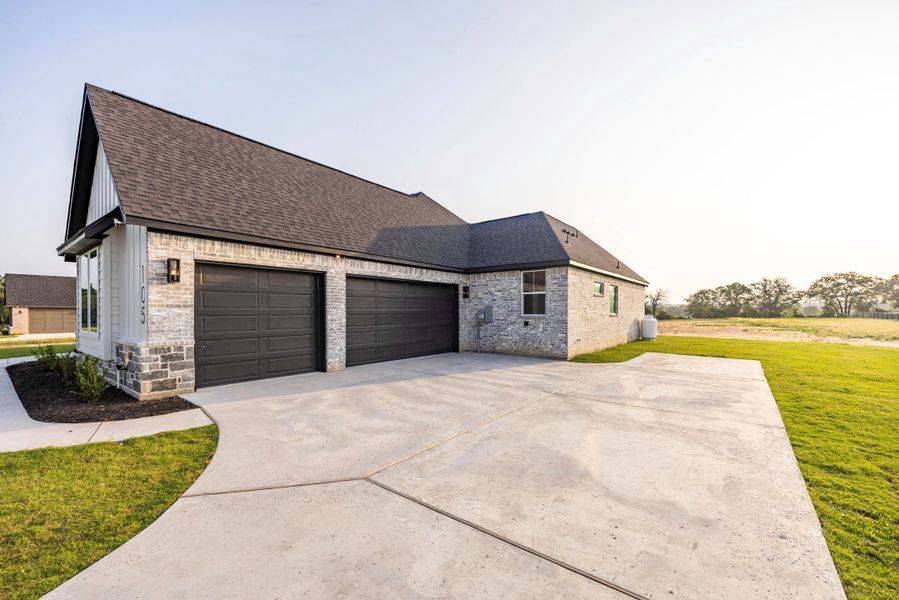 Front exterior of a new home in Prairie Winds Estates, Poolville, TX, highlighting curb appeal (Image 8). Front exterior of a new home in Prairie Winds Estates, Poolville, TX, highlighting curb appeal (Image 8).