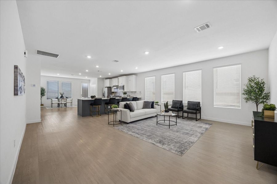 Open, airy and ready for real life, this spacious family room flows easily into the kitchen and dining areas, with LVP flooring and recessed lighting continuing throughout for a clean, cohesive feel. There is plenty of room to entertain, unwind or simply enjoy having a little extra breathing room.
