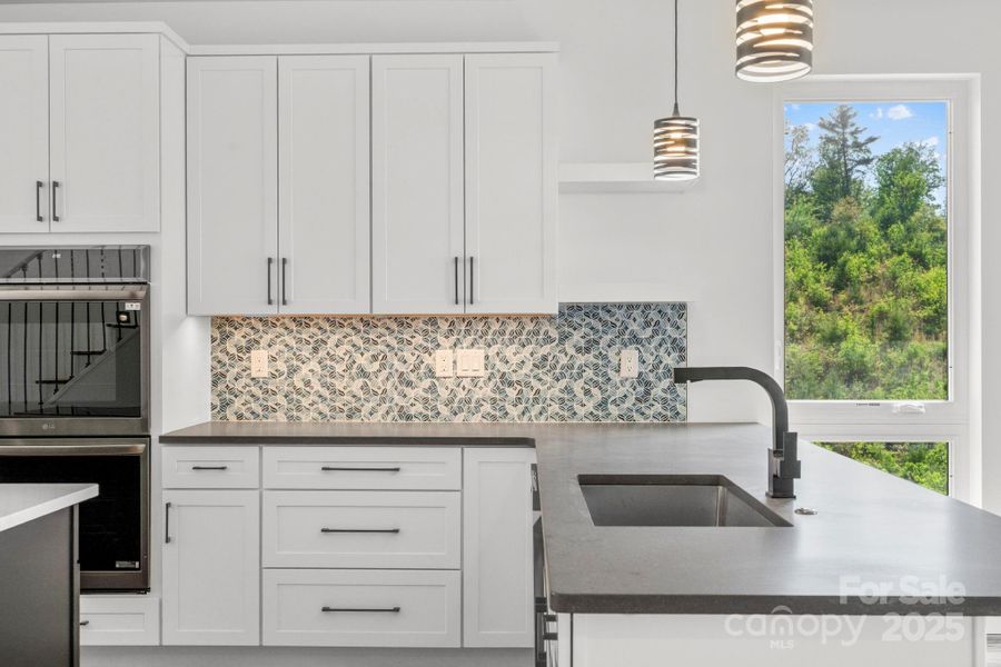 Upscale Kitchen with Modern Backsplash- Main Level