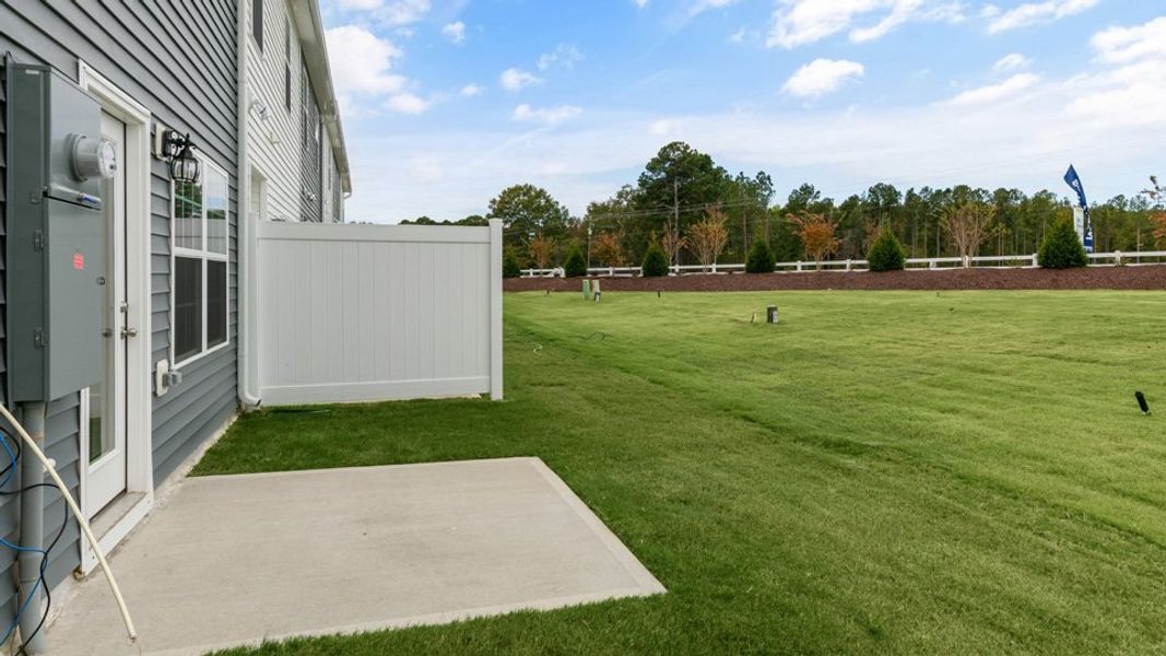Front exterior of a new home in Brightwood Farm, Whitsett, NC, highlighting curb appeal (Image 2). Front exterior of a new home in Brightwood Farm, Whitsett, NC, highlighting curb appeal (Image 2).