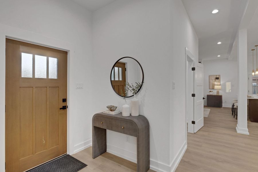 Inviting entryway featuring a solid wood front door, high ceilings, and recessed lighting—creating a bright and welcoming first impression. Inviting entryway featuring a solid wood front door, high ceilings, and recessed lighting—creating a bright and welcoming first impression.
