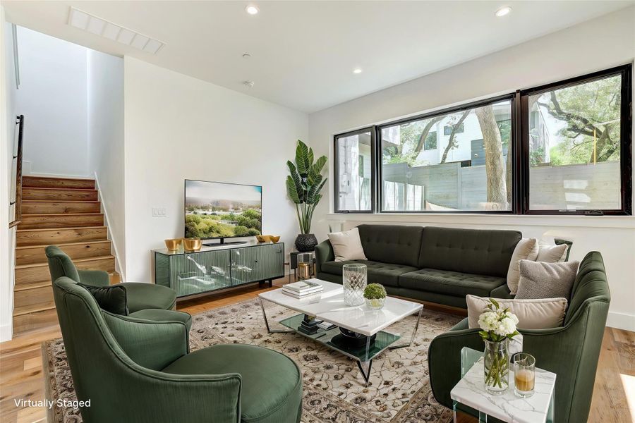 Living room with wood finished floors, stairs, recessed lighting, and baseboards