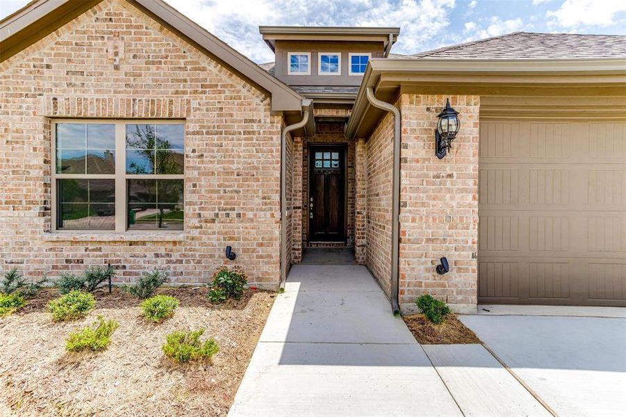 Doorway to property with a garage