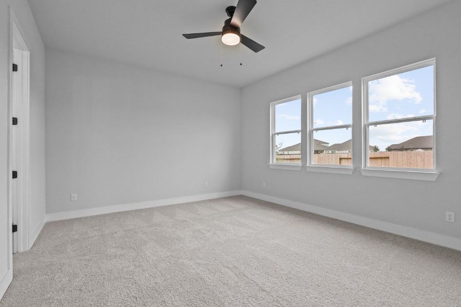 A room with a ceiling fan and a window with a view of the city. A room with a ceiling fan and a window with a view of the city.