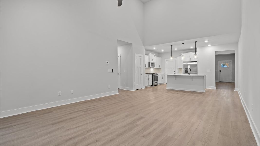 Refined and memorable, this family room features two-story ceilings and top-notch comfort throughout Refined and memorable, this family room features two-story ceilings and top-notch comfort throughout