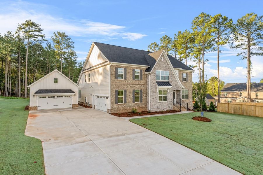 Front exterior of a new home in Suter Estates, Easley, SC, highlighting curb appeal (Image 2). Front exterior of a new home in Suter Estates, Easley, SC, highlighting curb appeal (Image 2).