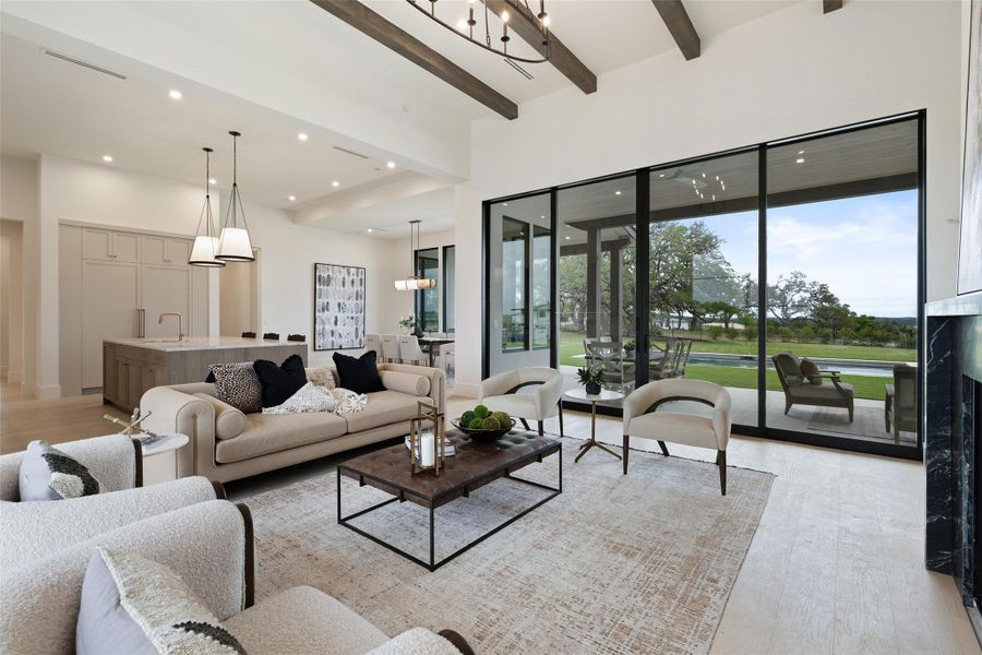 Living room featuring beamed ceiling, visible vents, recessed lighting, and light wood-type flooring Living room featuring beamed ceiling, visible vents, recessed lighting, and light wood-type flooring