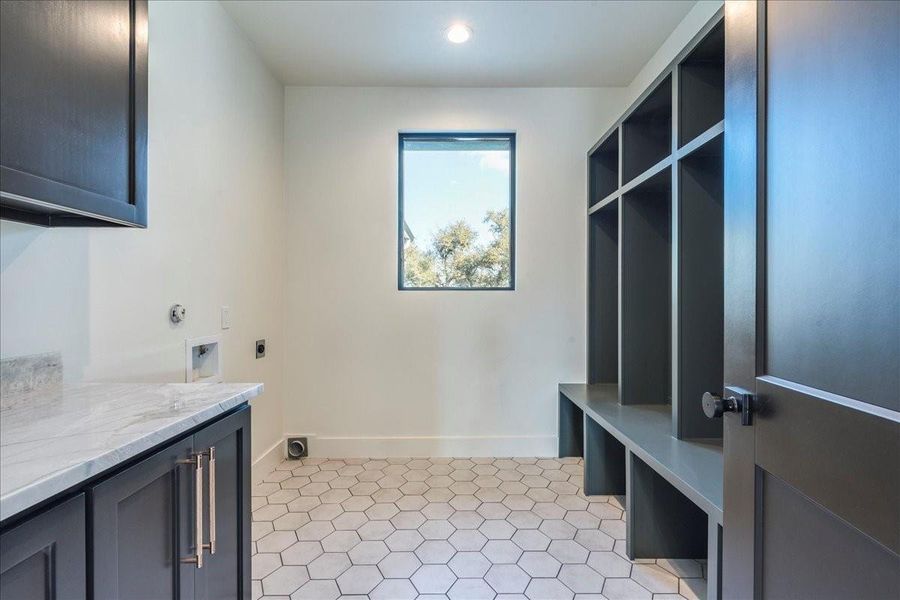 The laundry room is equally impressive, featuring a dedicated mudroom and custom details.