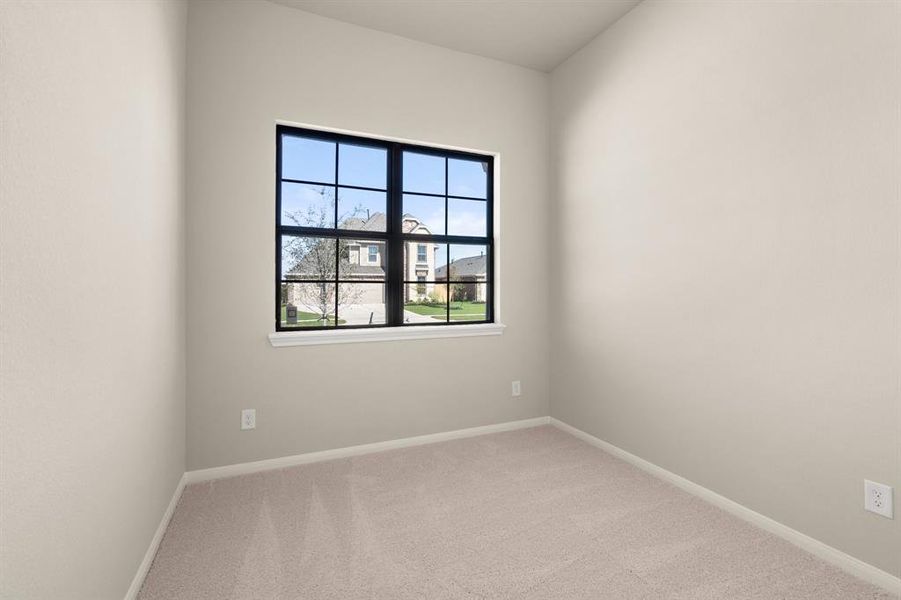 Your secondary bedroom features plush carpet, fresh paint, closet, and a large window that lets in plenty of natural lighting.