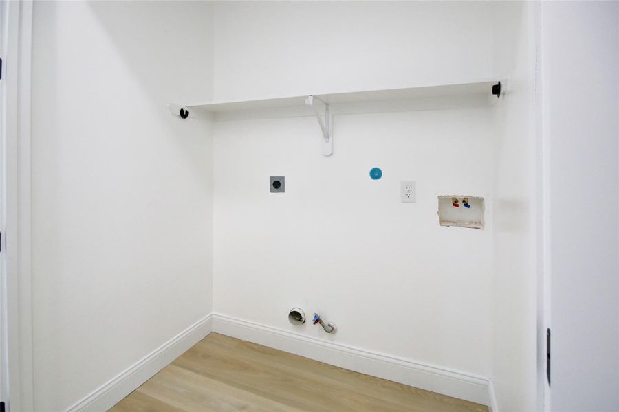 Laundry room on third floor between primary and secondary bedrooms. Laundry room on third floor between primary and secondary bedrooms.