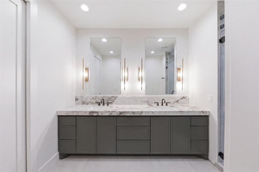 Indulge in spa-like luxury in the stunning primary bath featuring designer finishes, elegant details, and a serene atmosphere.