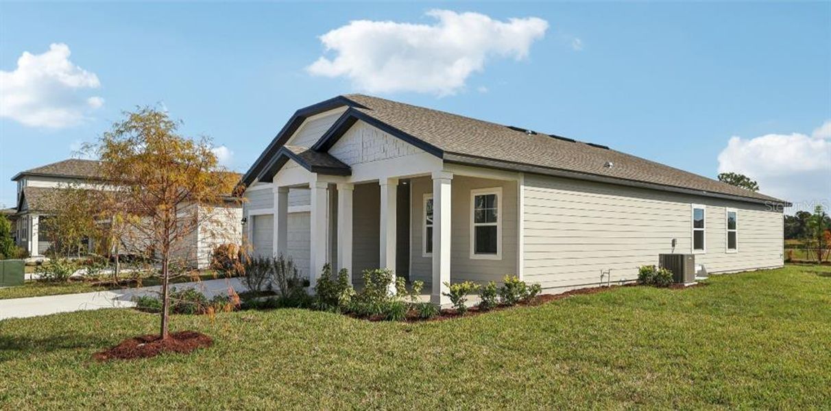 Front exterior of a new home in Ellington Traditional, St. Cloud, FL, highlighting curb appeal (Image 1). Front exterior of a new home in Ellington Traditional, St. Cloud, FL, highlighting curb appeal (Image 1).