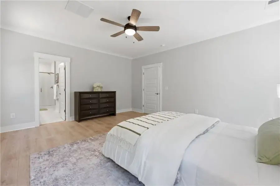 Smooth wood floors and elegant crown molding defin