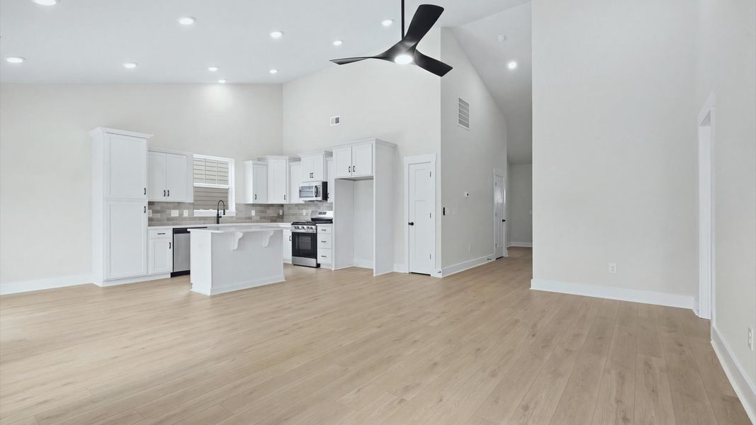 Vibrant family room with high-impact two-story ceilings and thoughtful layout for entertaining by DRB Homes