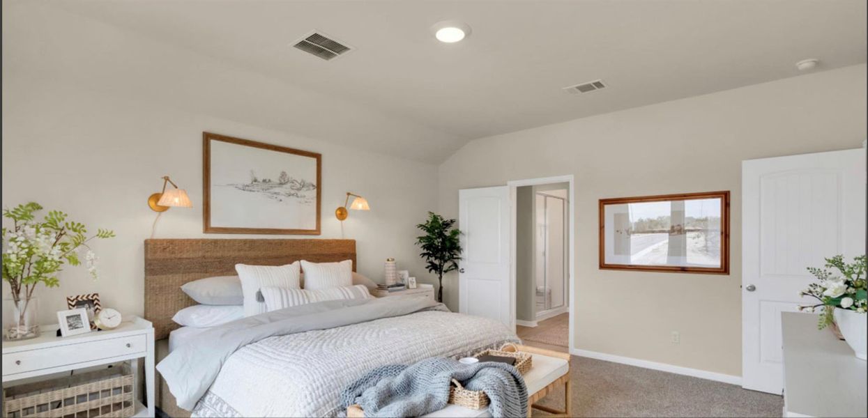Carpeted bedroom featuring lofted ceiling and baseboards