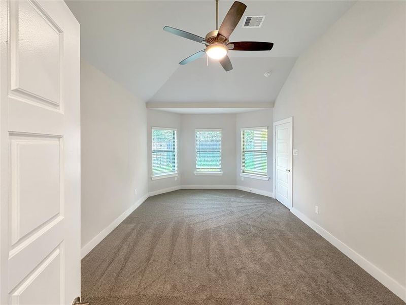 Spacious Master bedroom with high vaulted ceilings.