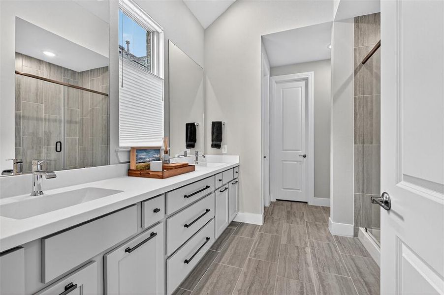 Bathroom with double vanity and a shower stall Bathroom with double vanity and a shower stall