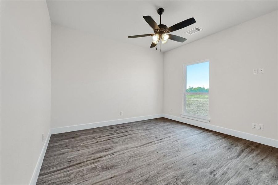 Spare room featuring ceiling fan and hardwood / wood-style floors