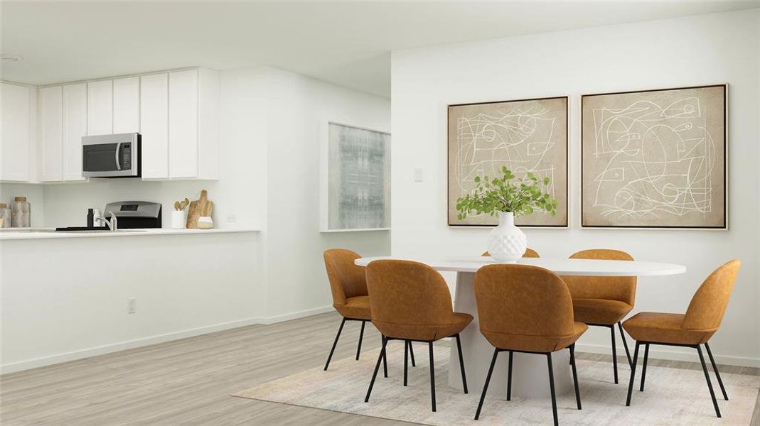 Dining room with light wood-style floors and baseboards