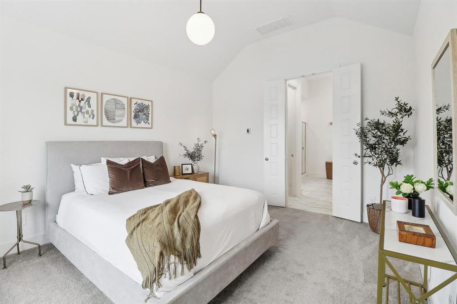 Bedroom featuring visible vents, carpet flooring, and lofted ceiling Bedroom featuring visible vents, carpet flooring, and lofted ceiling