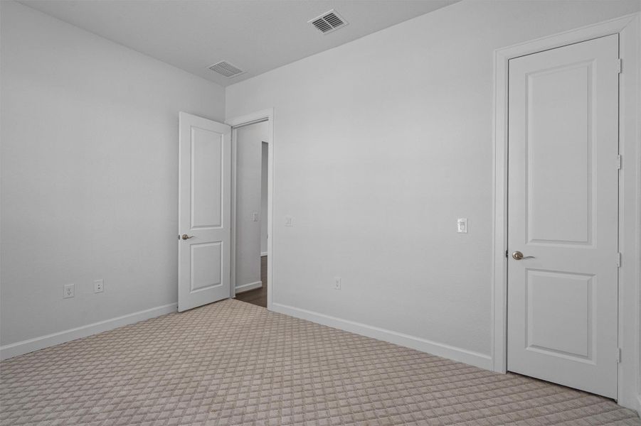 Spare room with carpet flooring and baseboards Spare room with carpet flooring and baseboards