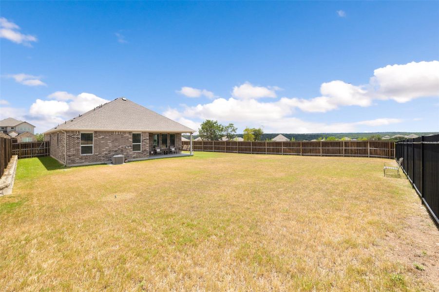 Fenced backyard featuring a patio area Fenced backyard featuring a patio area